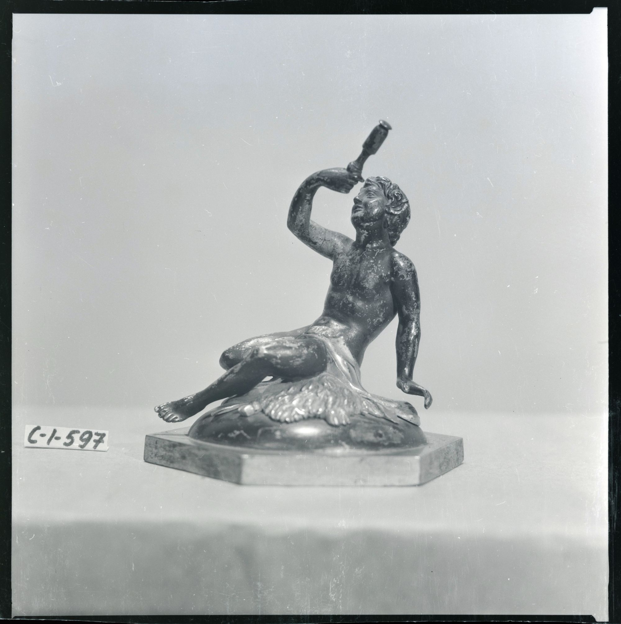 A Faun Examining His Find