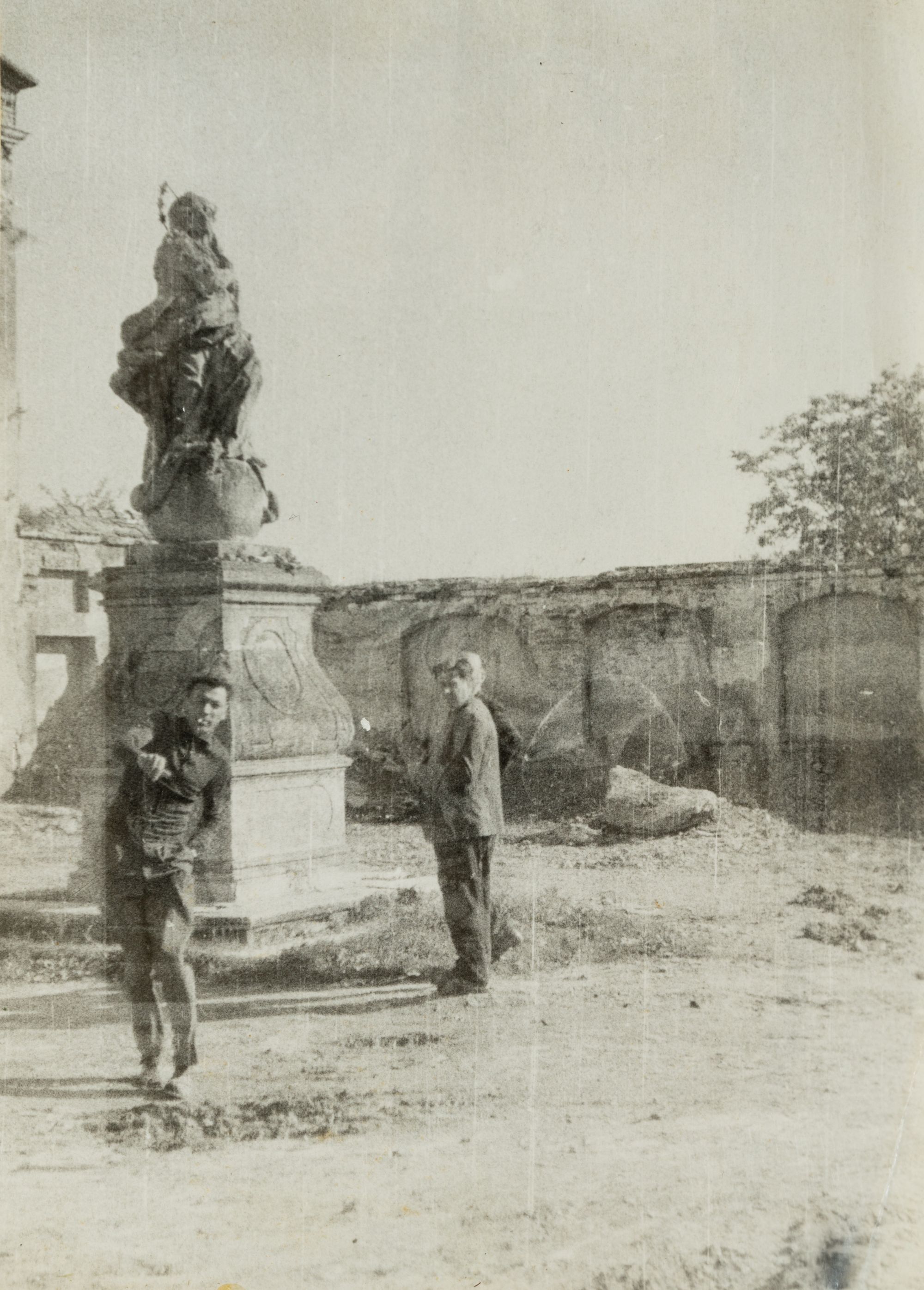 Men Next to a Sculpture of the Virgin Mary on the Territory of the Capuchin Monastery